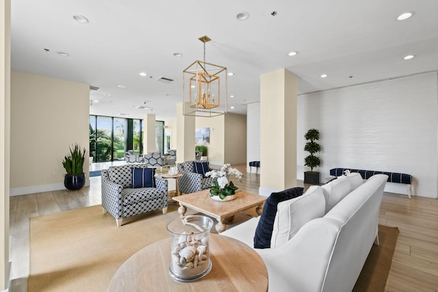 living area featuring recessed lighting, visible vents, light wood-style flooring, and an inviting chandelier