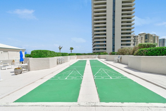 view of property's community featuring shuffleboard