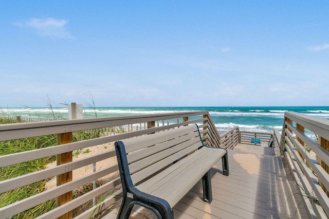 surrounding community featuring a water view and a view of the beach