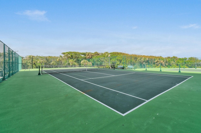 view of tennis court with fence