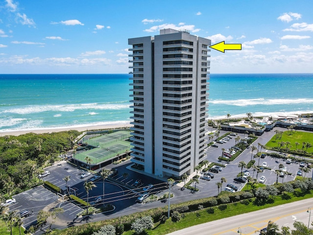 bird's eye view featuring a water view and a beach view