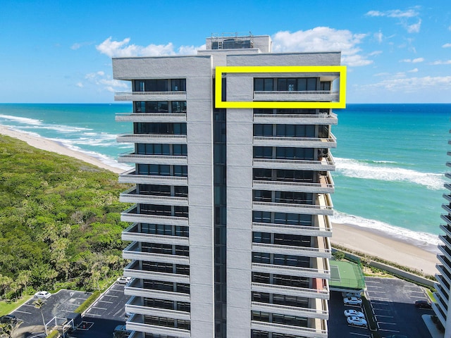 view of property featuring a view of the beach and a water view