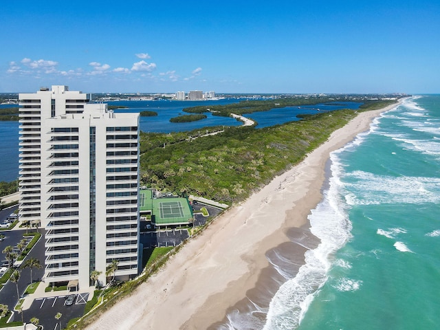 birds eye view of property featuring a beach view and a water view