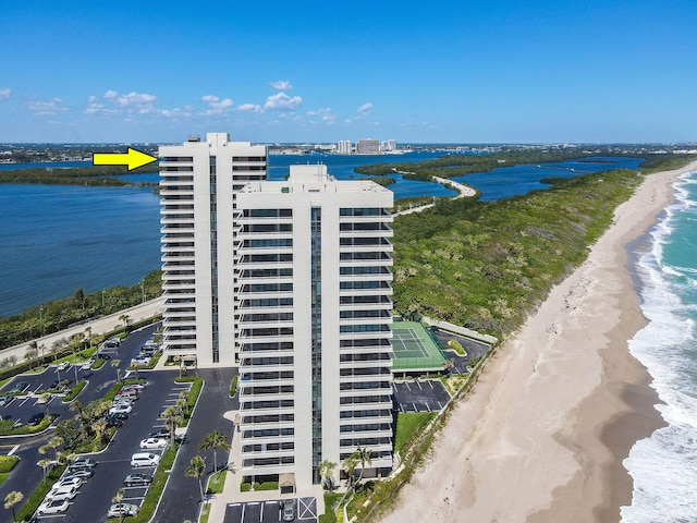 drone / aerial view featuring a beach view and a water view