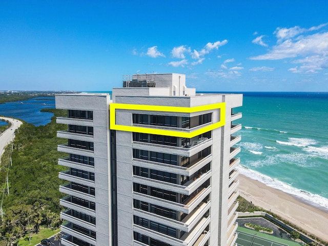 exterior space featuring a view of the beach and a water view