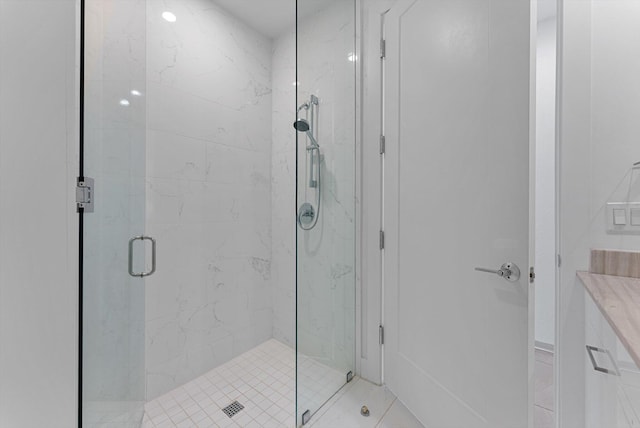 bathroom with vanity and a shower with shower door