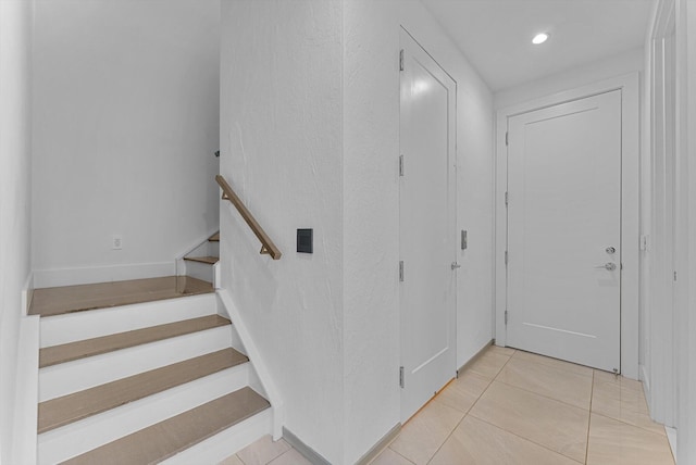 stairway featuring tile patterned flooring