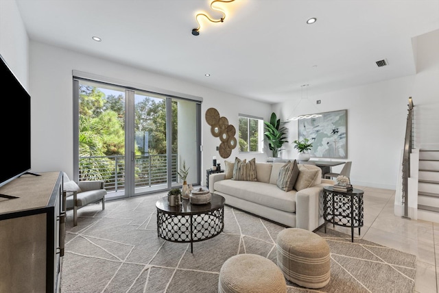 tiled living room featuring a wealth of natural light