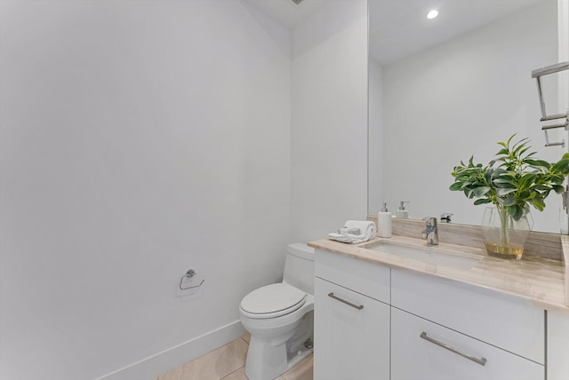 bathroom featuring toilet, vanity, and tile patterned flooring