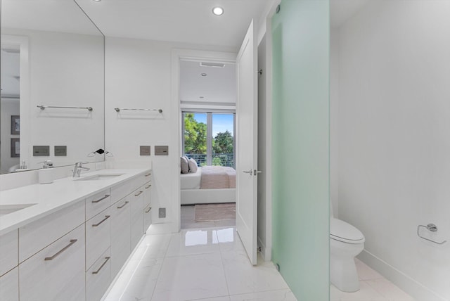 bathroom featuring toilet and vanity