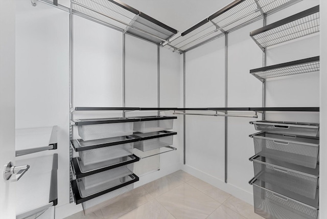 spacious closet featuring light tile patterned flooring