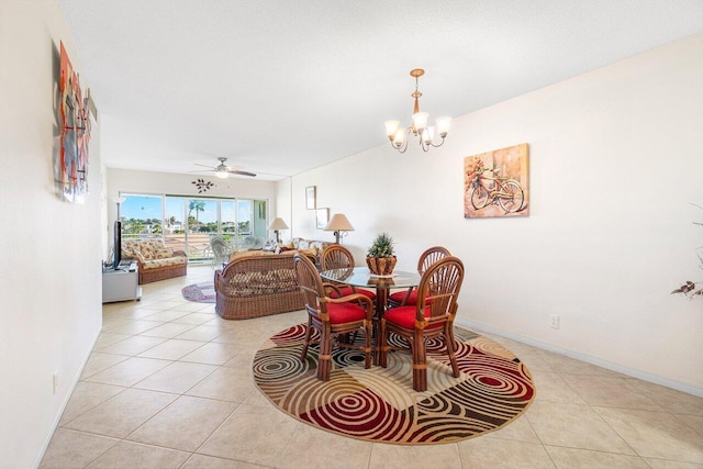 dining space featuring ceiling fan with notable chandelier and light tile patterned floors