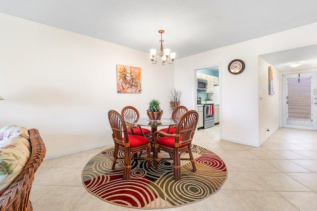 tiled dining room featuring a notable chandelier