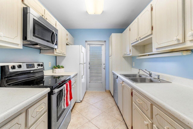 kitchen featuring sink, light tile patterned floors, and stainless steel appliances