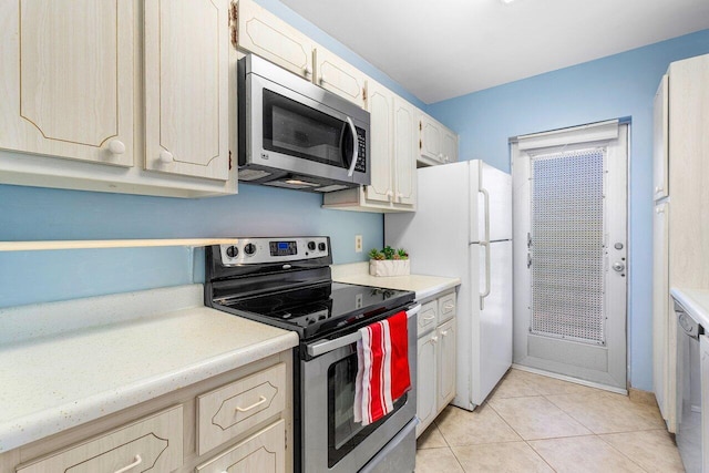 kitchen featuring light tile patterned floors, stainless steel appliances, and light brown cabinetry