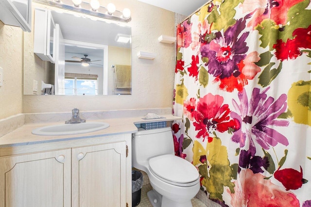 bathroom with vanity, toilet, and ceiling fan