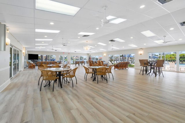 dining room with ceiling fan, a drop ceiling, and a wealth of natural light