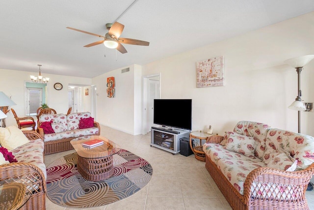 living room featuring ceiling fan with notable chandelier and light tile patterned flooring