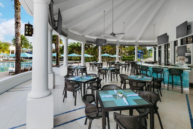 view of patio featuring ceiling fan and an outdoor bar