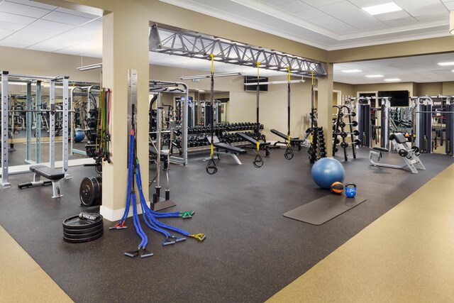 workout area featuring crown molding and a drop ceiling