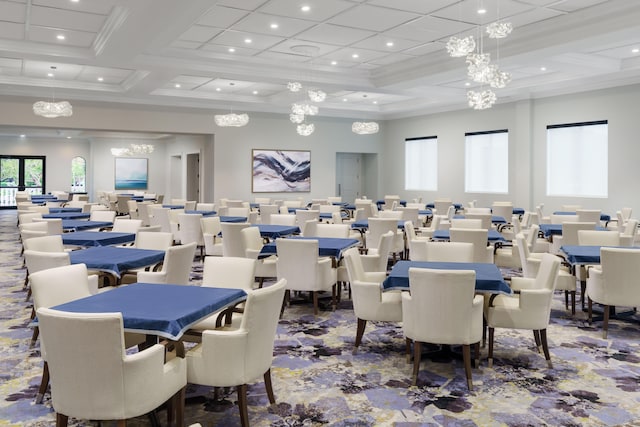 carpeted dining space with ornamental molding and coffered ceiling