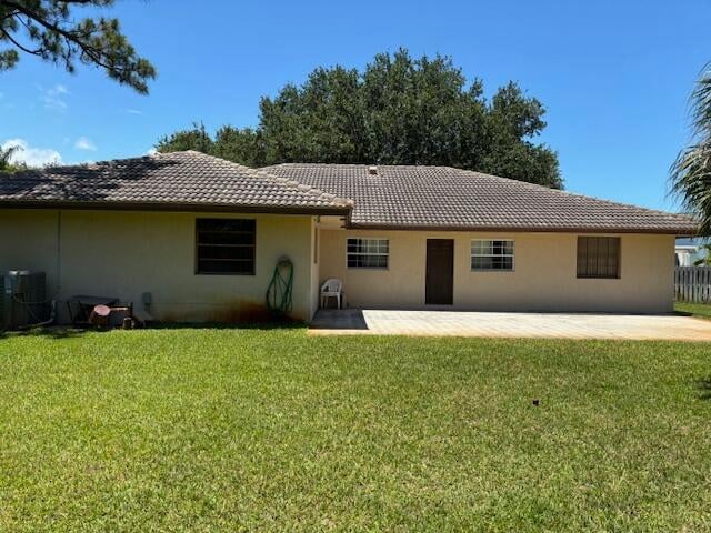 back of house featuring a yard, a patio area, and central AC unit