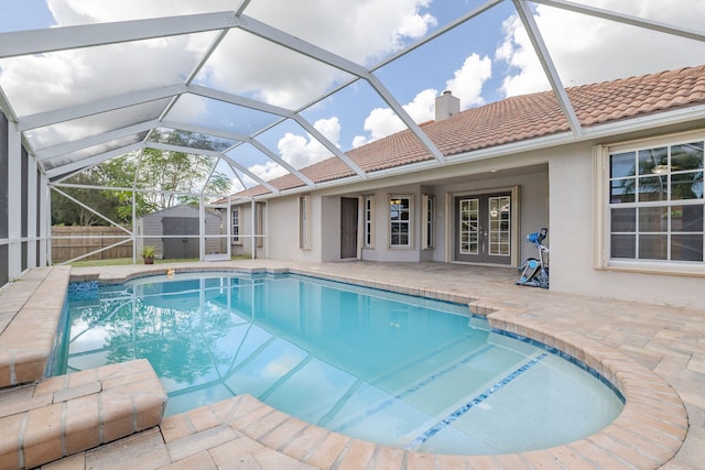 view of pool featuring a lanai, a storage shed, and a patio area