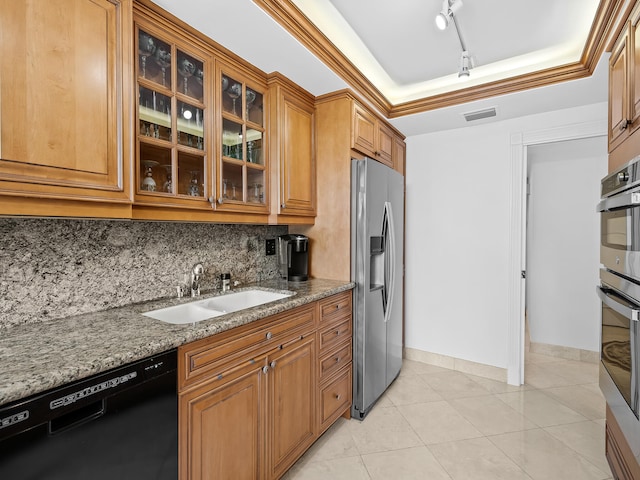 kitchen featuring decorative backsplash, appliances with stainless steel finishes, sink, and light stone counters