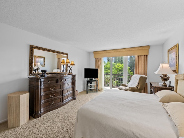 carpeted bedroom featuring access to outside and a textured ceiling