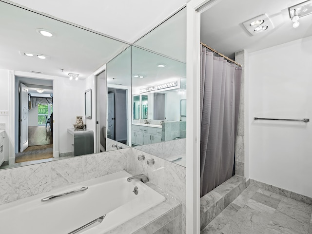 bathroom featuring vanity and shower with separate bathtub