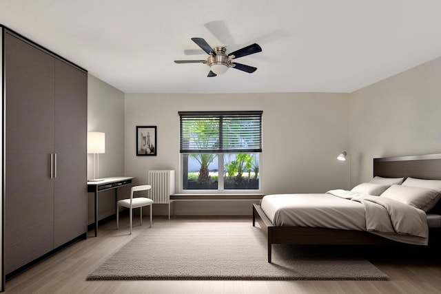 bedroom featuring light hardwood / wood-style flooring and ceiling fan