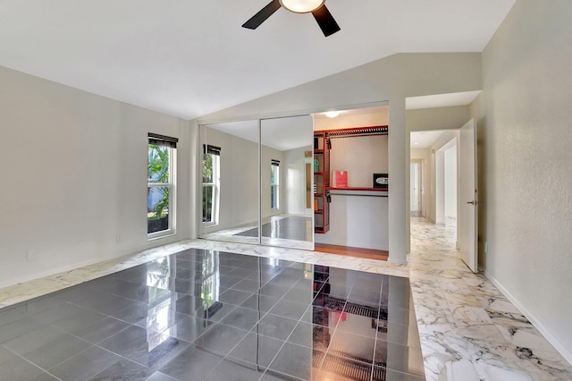 interior space featuring ceiling fan and lofted ceiling