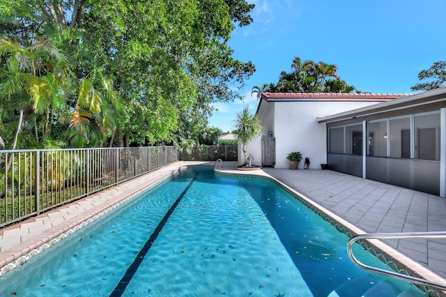 view of pool with a sunroom