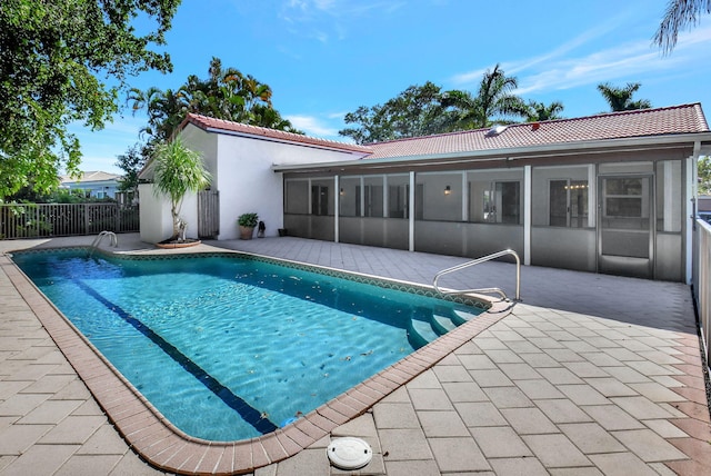 view of pool featuring a sunroom and a patio area