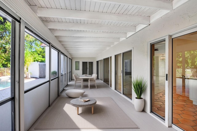 sunroom with beamed ceiling