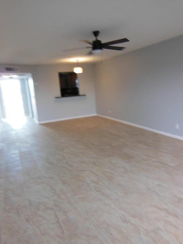 unfurnished living room featuring ceiling fan