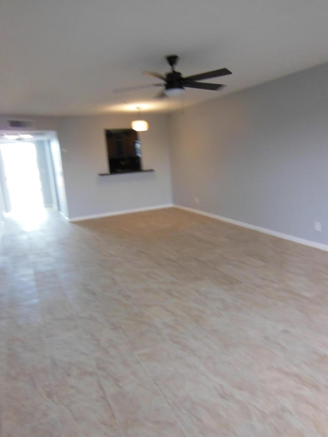 405 US Highway 1 Unit 307, Palm Beach Gardens, FL 33408 - unfurnished living room featuring ceiling fan and baseboards