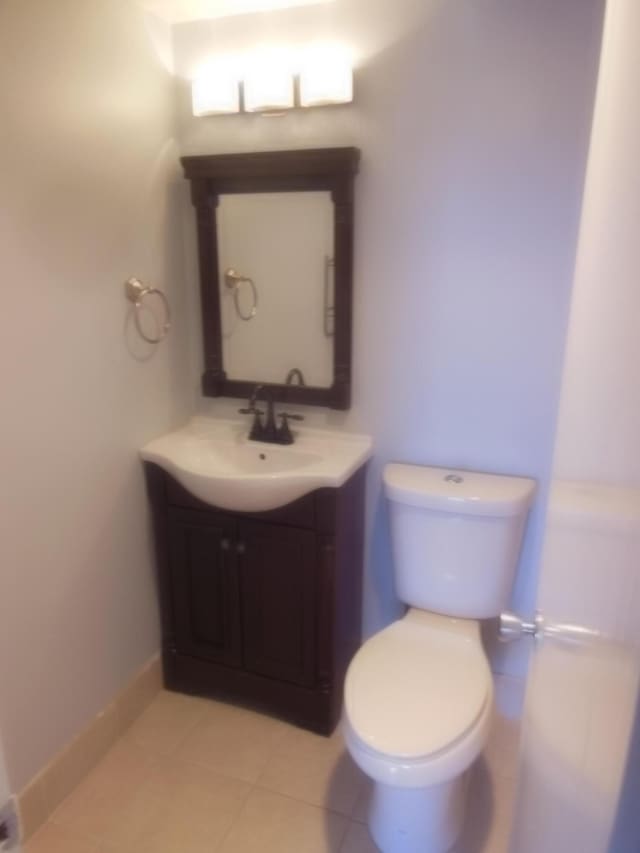 bathroom featuring vanity, toilet, and tile patterned floors