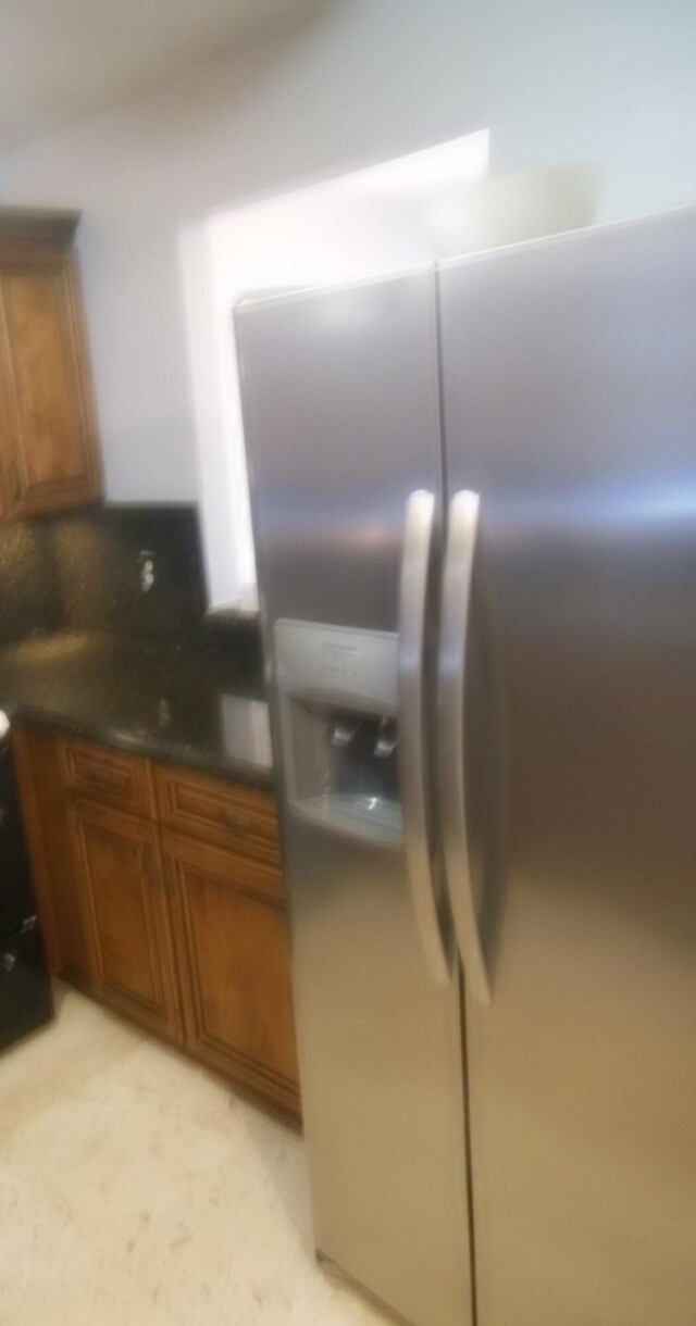405 US Highway 1 Unit 307, Palm Beach Gardens, FL 33408 - kitchen with stainless steel fridge, brown cabinets, and dark countertops