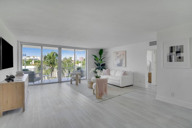 unfurnished living room featuring light hardwood / wood-style floors and expansive windows