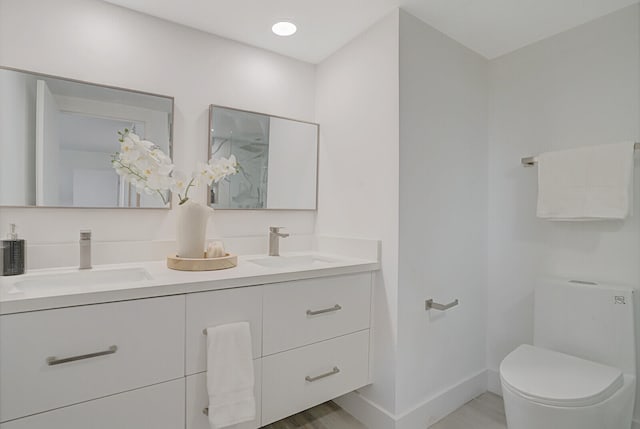 bathroom featuring toilet and vanity