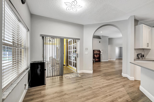 interior space with light hardwood / wood-style floors and a textured ceiling