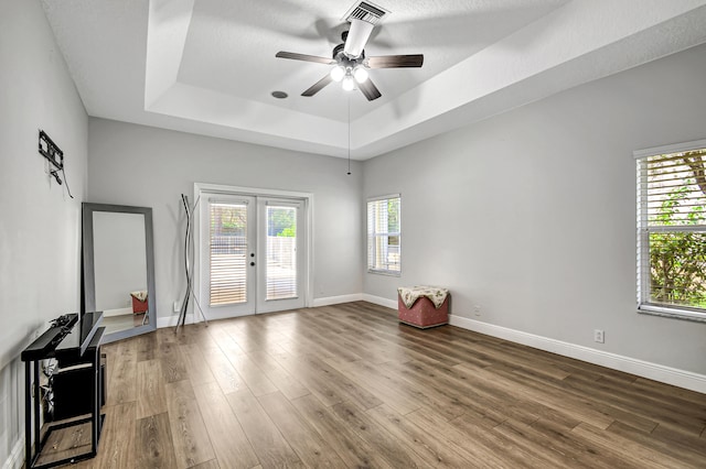 unfurnished room featuring hardwood / wood-style floors, french doors, a healthy amount of sunlight, and ceiling fan