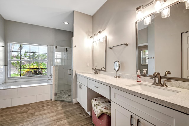 bathroom featuring shower with separate bathtub, vanity, and hardwood / wood-style flooring