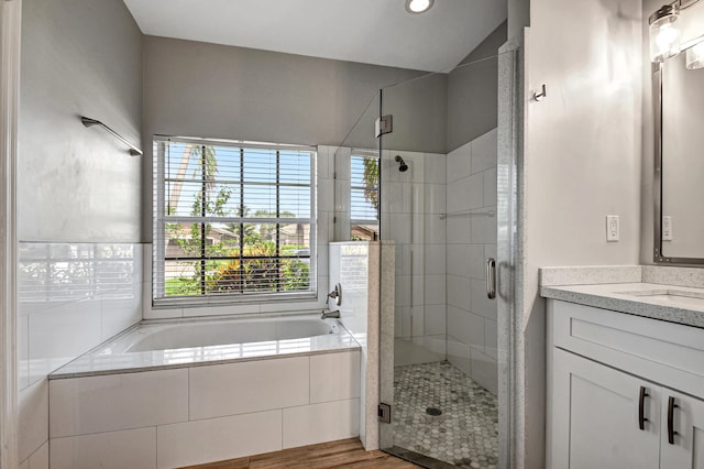 bathroom with vanity, hardwood / wood-style flooring, and independent shower and bath