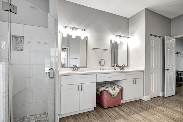 bathroom featuring vanity and a shower with door