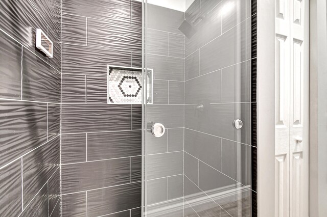 bathroom with tiled shower