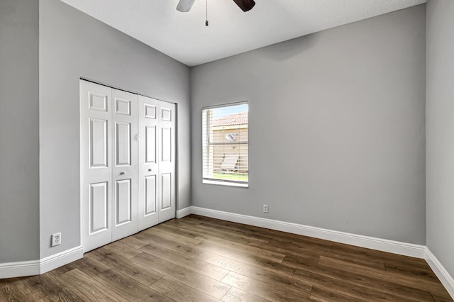 unfurnished bedroom featuring a closet, hardwood / wood-style floors, ceiling fan, and a textured ceiling