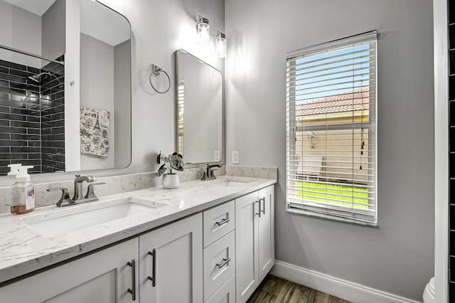 bathroom with vanity, a healthy amount of sunlight, and wood-type flooring