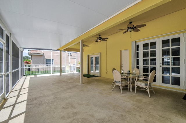 sunroom / solarium with ceiling fan and french doors